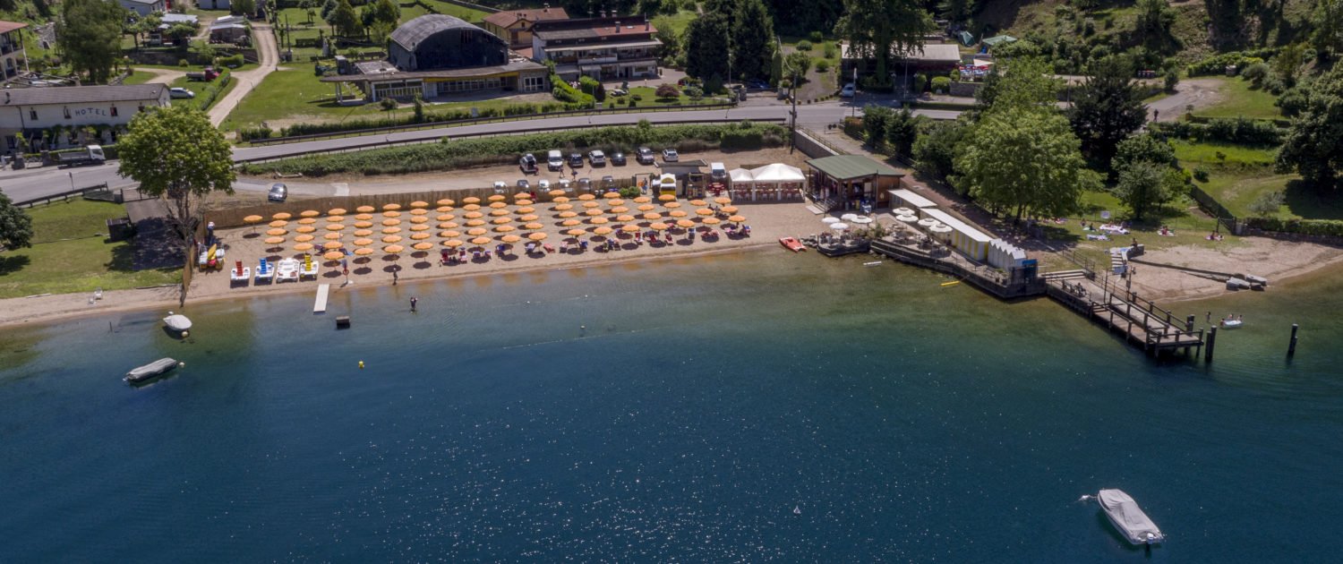 Aerial view of Alice Beach on Lake Maggiore with clear blue water and sandy shore