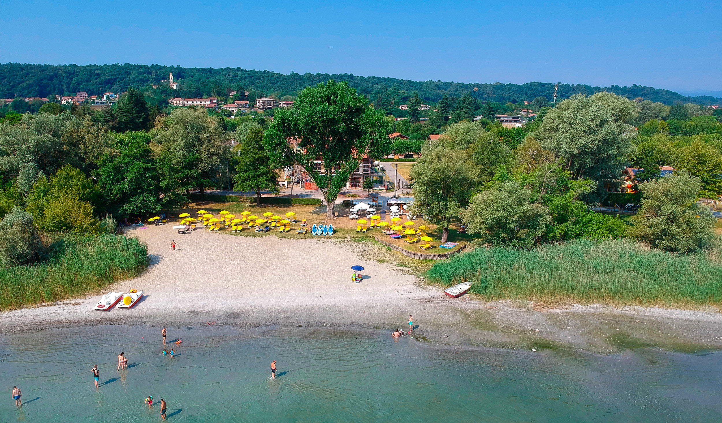 Panoramic view of Alice Beach on Lake Maggiore with calm waters and scenic surroundings
